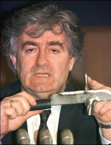 Serb leader Radovan Karadzic holds a knife.