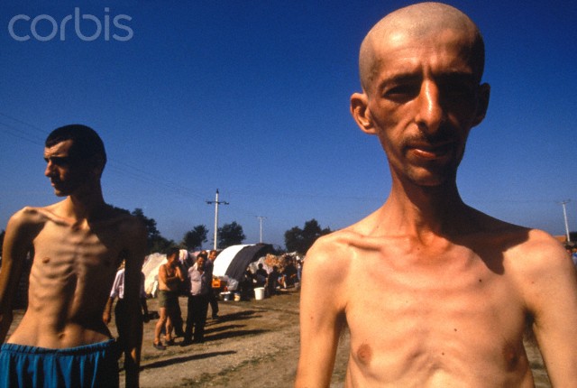 Bosnian Genocide, 1992: Non-Serb civilians imprisoned in the Serb-run Trnopolje concentration camp near Prijedor in 1992. Thousands of prisoners, mostly Bosniaks, were tortured and killed there in 1992. Photographer: Ron Haviv
